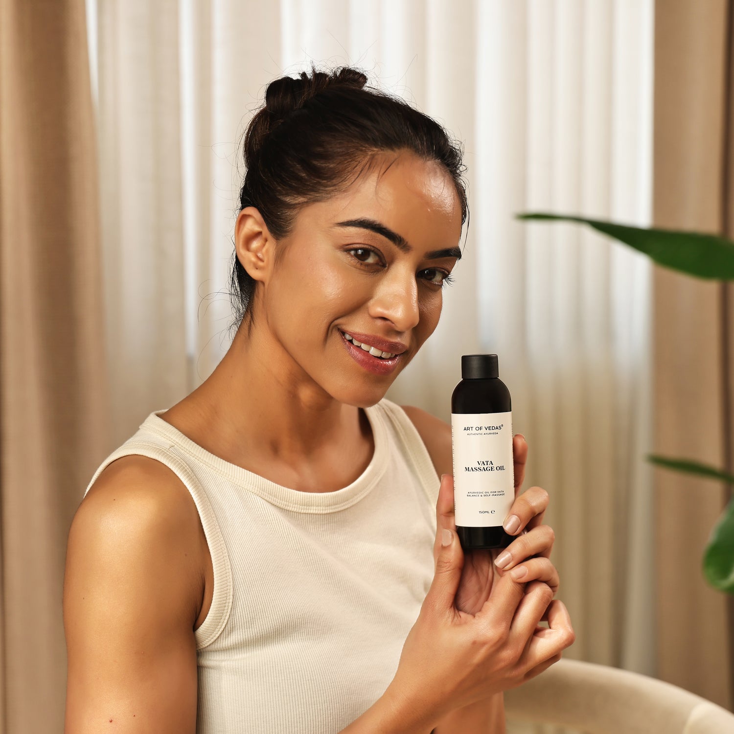 Art of Vedas Abhyanga Oils - Woman Holding Ayurvedic Abhyanga Massage Oil Bottle for Nourishing Full Body Oil Therapy