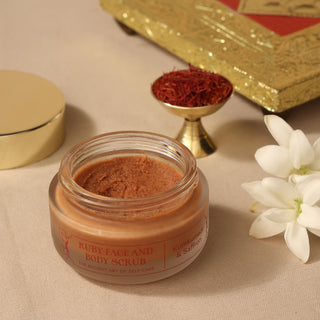 A close up view of Ruby Face and Body Scrub with Kumkumadi Thailam, Kumkumadi Oil, Saffron, Almonds. The scrub is organic, natural that gently exfoliates, deep cleans, and clarifies your skin, leaving it feeling smooth, radiant, and revitalized. This scru